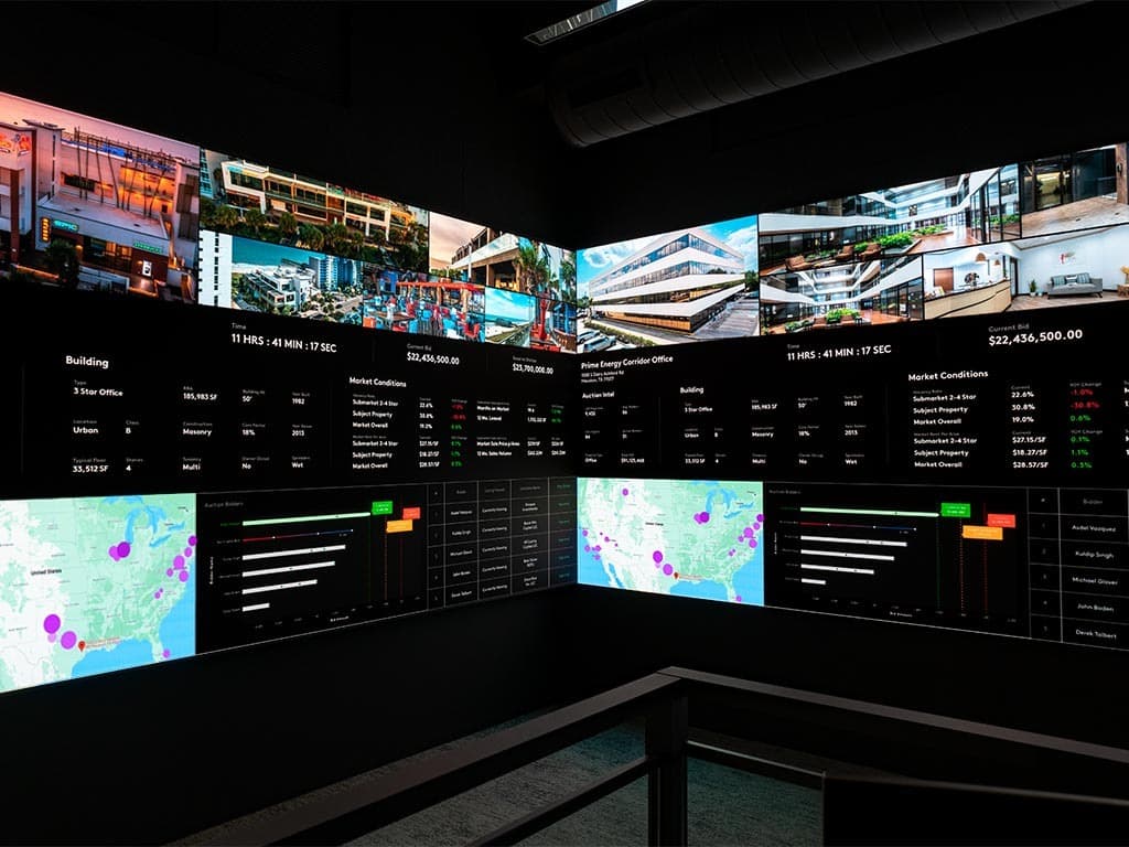 Ten-X auction floor, both 60-foot wraparound LED walls meeting at 90° with live auction UI, bidder map, and ranked bidder list