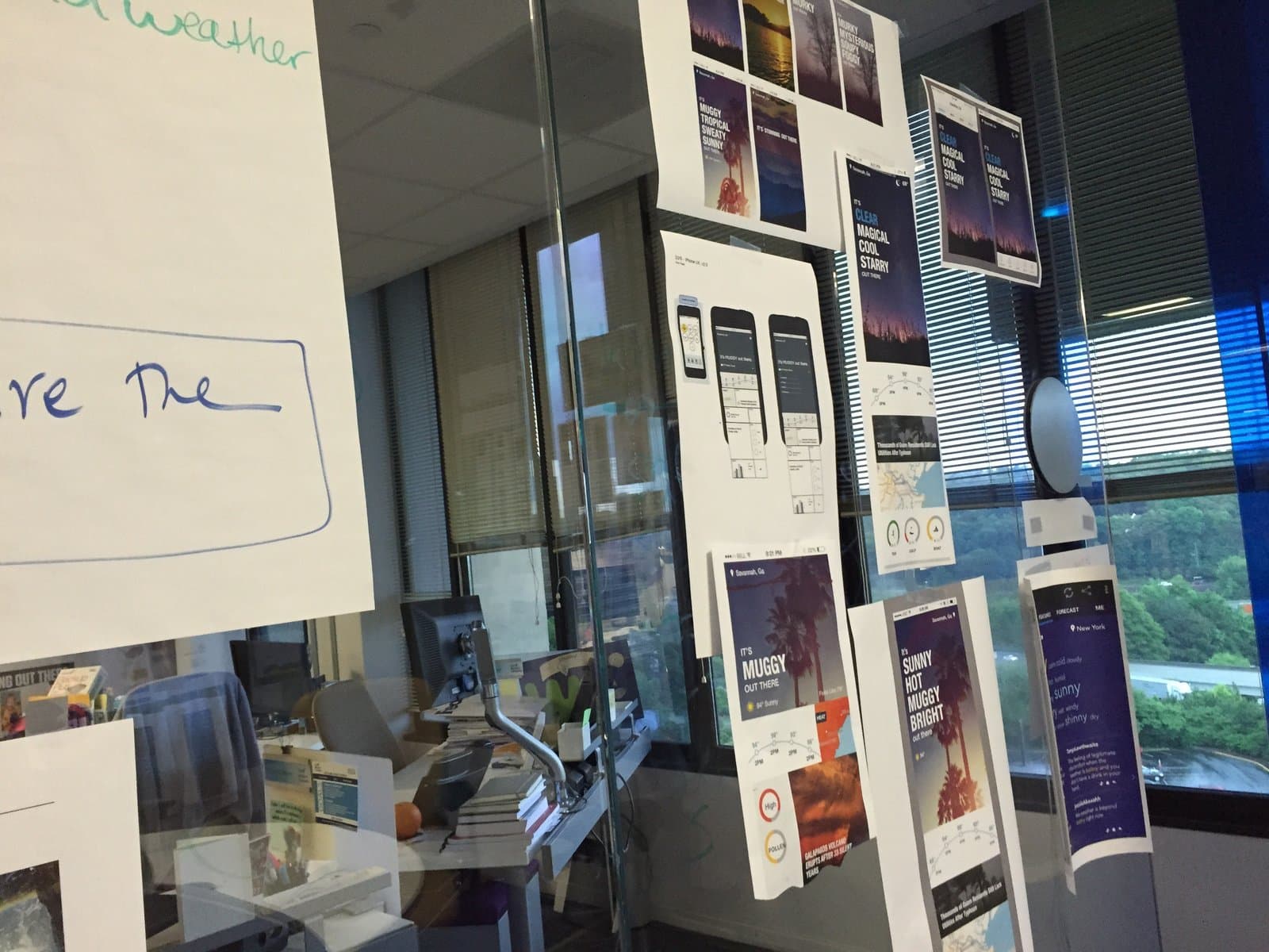 Weather Channel design sprint, mobile app designs printed and hung on glass critique wall